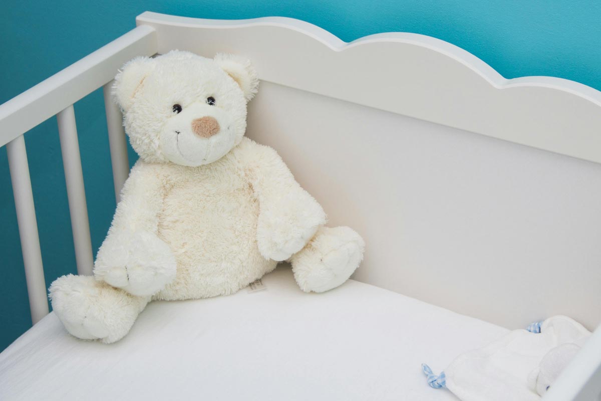 Teddy bear in crib